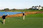 UK,Northern Ireland,Fermanagh. Couple playing golf on the new course designed by Nick Faldo at Lough Erne Golf Resort .