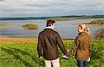 UK,Northern Ireland,Fermanagh. A couple out for a walk overlooking the lake at Lough Erne Golf Resort .