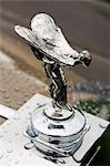 The iconic Spirit of Ecstasy emblem on the bonnet of a Rolls Royce luxury car