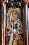 England,Devon,Dartmoor National Park,Manaton. The 15th century St Winifreds Church with its Tudar Rose and Fleur de Lis decorations rod screen,commemorating many Christian saints and martyrs. When the Reformation came to England towards the middle of the sixteenth century a decree from the Privy Council in 1548 ordered all superstitious images to be taken down or defaced.