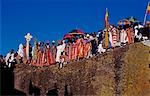 Ethiopian Christmas day celebrations (Genna),Bet Maryam Church,Lalibela,Ethiopia. Holy men carry Axunite hand crosses. Cloths are used when holding these,to keep them clean. Colourful umbrellas are also an important part fo the religious symbolism employed in Ethiopia.