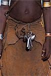 A young Dassanech girl wears a leather skirt,metal bracelets and amulets and layers of bead necklaces. Much the largest of the tribes in the Omo Valley numbering around 50,000,the Dassanech (also known as the Galeb,Changila or Merille) are Nilotic pastoralists and agriculturalists.
