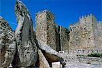 Tourists sit in front of the imposing towers of the mediaeval castle. Francisco Pizarro,the conqueror of Peru,was born here.