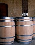 Bottles of Muga Reserva and Torre Muga on top of new wine barrels at Muga winery