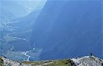 A cyclist on a mountain bike tour of Mont Blanc stops to take in the view,Grand Col de Ferret.