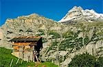 A mountain hut sits below the peak of the Jungfrau,Interlaken,Jungfrau Region,Switzerland