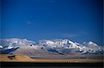 Tibet,Tingri,Cho Oyu (8,201m). View across the Tingri Plain with the Cho Oyu massif in the background. This high altitude plateau,above 15,000ft,stretches across the northern approaches to the Himalayan mountain ranges. Most adventure tours will cross the Tingri Plain to reach Mount Everest or to make the 10,000 ft descent into Nepal.