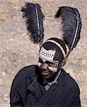 Black clothing,Black ostrich feathers and the intricate white patterns on the face of this Maasai youth of the Kisongo section signify his recent circumcision.