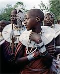 Maasai girls gather to celebrate a wedding. Their broad beaded necklaces with predominantly white glass beads mark then as Kisongo Maasai,the largest clan group of the tribe which lives either side of the Kenya-Tanzania border.