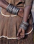 The numerous decorated iron bracelets worn by a Datoga woman. During song and dance,she will rub them together to keep rhythm. Her traditional attire includes a beautifully tanned leather dress embellished with beads. The Datoga (known to their Maasai neighbours as the Mang'ati and to the Iraqw as Babaraig) live in northern Tanzania and are primarily pastoralists.