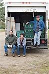 Three farmers by truck