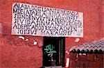 A carved inscription frames a window.