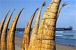 Caballitos de totora (reed boats) are stacked along the beach to dry at Huanchaco in northern Peru. The boats have been used by fishermen on Peru's northern coast for over two thousand years.