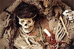 Le crâne d'une momie de Nazca, entouré par des fragments de poterie, des os et des tissus dans le cimetière de Chauchilla, sud du Pérou.
