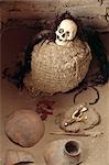 The skull of a Nazca mummy surrounded by pottery,bone and cloth fragments in the Cemetery of Chauchilla in Peru.