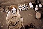 A Nazca mummy is surrounded by pottery,bone and cloth fragments in the Cemetery of Chauchilla in Peru.