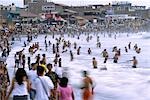 The summer crowds flock to the beach at Huanchaco,near Trujillo in northern Peru. The town is famous for its fishermen that use traditional reed boats to ride the surf.