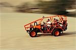 A dune buggy speeds tourists acoss through the sand dunes near Huacachina,in southern Peru.