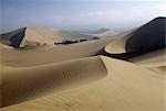 Desert dunes skirting the oasis village of Huacachina,in southern Peru