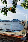 Philippines,Luzon,Batangas,Talisay. Colourful Banka fishing boats on Lake Taal with Taal volcano in the background.