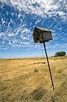 South Africa,Western Cape,Swartland,Darling. An abandoned bird box leaning lazily to one side on farmland near the small town of Darling.