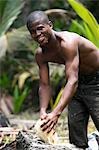 Sao Tomé and Principé. A young Sao Tomense breaks open a coconut on a rock. They say that more people die in Sao Tomé from coconuts falling on their heads than from hunger. Sao Tomé and Principé is Africa's second smallest country with a population of 193 000. It consists of two mountainous islands in the Gulf of New Guinea,straddling the equator,west of Gabon.