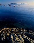 Fishing boats rest at anchor on a still evening at Rum Elgol on the west coast of Skye.