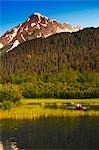Man in a kayak paddling in a lake in Portage Valley, Southcentral, Alaska, Summer