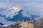 Hikers climb in the afternoon sun on a ridge above the Juneau Ice Field, Juneau, Alaskain the Tongass National Forest