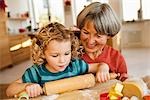 grandchild and grandma rolling dough