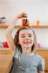 young girl playing with fruit