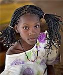 Mali,Gao. A young Songhay girl at Gao market with a fetching modern hairstyle.