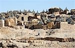 Mali,Dogon Country. An attractive Dogon village on top of the Bandiagara escarpment. The toguna or men’s meeting house is the domed-shaped building on the skyline with dried grass on the roof. Dwellings have flat roofs while the square granaries have pitched thatched roofs.