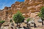 Mali,Dogon Country,Tereli. The typical Dogon village of Tereli situated among rocks at the base of the 120-mile-long Bandiagara escarpment. Dwellings have flat roofs while granaries to store millet have pitched thatched roofs.