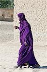 Mali,Timbuktu. An old woman walks through the sandy streets in Timbuktu.