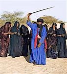 Mali,Timbuktu. A group of Tuareg men and women sing and dance near their desert home,north of Timbuktu.