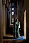 Mali,Niger Inland Delta. The imam of Kotaka pauses beside an archway inside the impressive Sudan-style mosque which dominates Kotaka village on the banks of the Niger River.