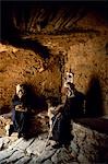 Berber men sit at the entrance to an agadir or fortified granary