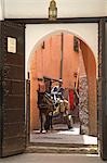 Un homme roule un chariot d'âne à travers les rues de la vieille médina, Marrakech.