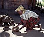 A girl makes clay pots near Liwonde. .