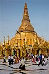 Myanmar,Burma,Yangon. Devout Buddhists at the small stupas,temples,shrines,prayer halls,and pavilions at the Shwedagon Golden Temple.