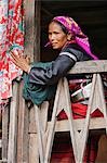 Myanmar. Burma. Wanpauk village. A Palaung woman of the Tibetan-Myanmar group of tribes displays her wealth by wearing broad silver belts around her waist.