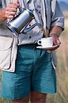 Safari guide pours coffee,Elsa's Kopje.