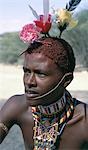 The adornments of Samburu warriors change from generation to generation. In the 1990's cheap plastic flowers from China became fashionable.