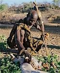 Kenya,Rift Valley Province,Lokiriama. A Turkana soothsayer acts as a healer to diagnose the cause of a person’s illness by examining the intestines of a specially slaughtered goat before smearing his patient with its chyme - the partially digested stomach contents of the animal.