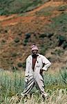 Basotho elder with pipe working in fields.