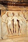 Carved depiction of the three graces - in one of the curved niches found on the stage in the theatre at Sabratha,Libya.