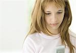 Preteen girl looking at cell phone