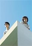 Two young men, low angle view with sky in background