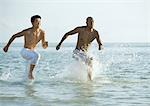Two men running in sea